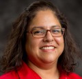 A woman smiles for a headshot