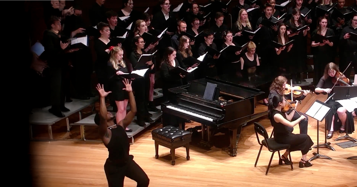 A dancer performs with the Grinnell Singers